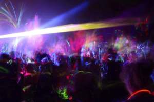 Color neon streaks of light glow sticks at a night celebration and rave